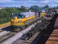 Rumbling northbound, ONR Extra 1515 snakes through Richmond Hill, passing various pieces of work equipment and supplies in the sidings.  The CNR freight shed can be seen in the distance, with the station just beyond.

<br><br><a href=https://www.railpictures.ca/?attachment_id=59055>Departing Toronto Yard</a>
<br><a href=https://www.railpictures.ca/?attachment_id=58160>Richmond Hill south end</a>

<br><br><i>Scan and editing by Jacob Patterson.</i>