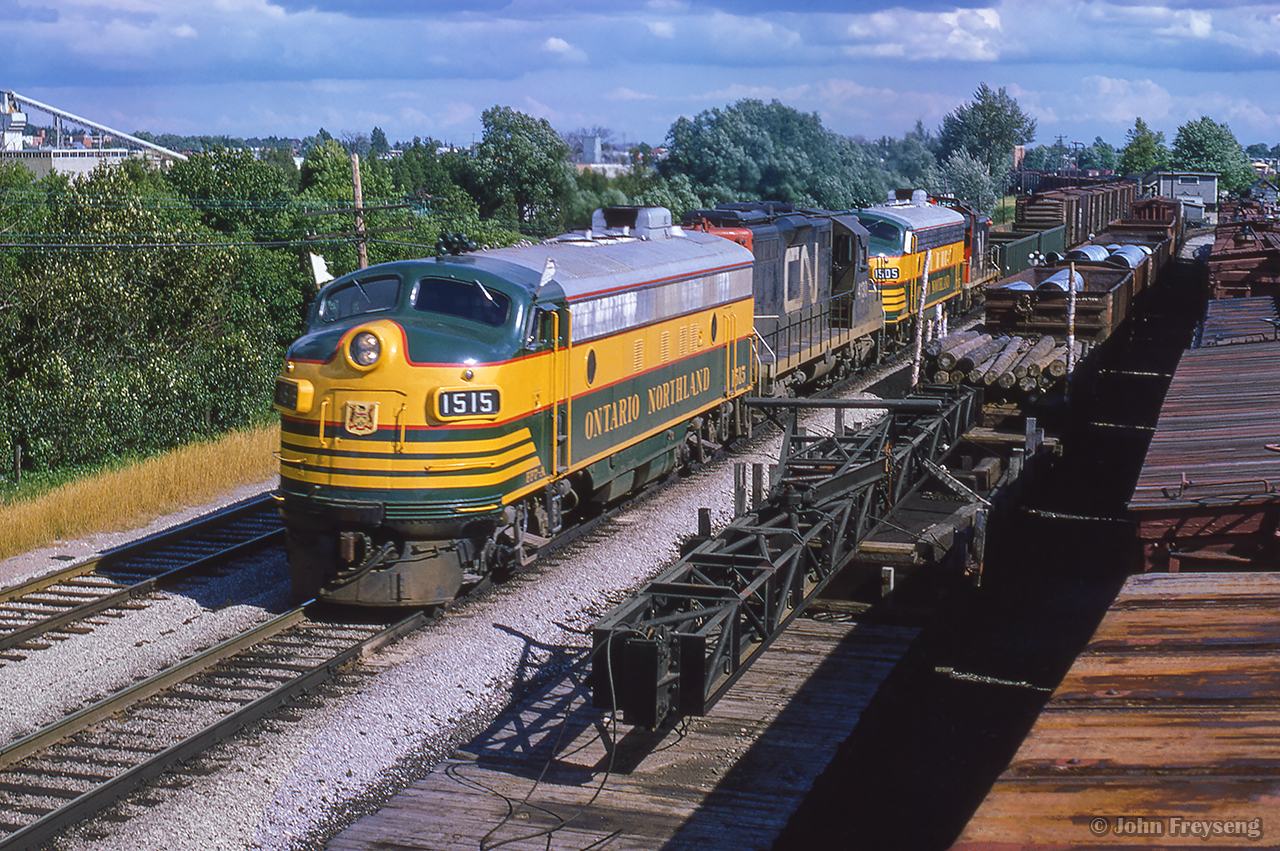 Rumbling northbound, ONR Extra 1515 snakes through Richmond Hill, passing various pieces of work equipment and supplies in the sidings.  The CNR freight shed can be seen in the distance, with the station just beyond.

Departing Toronto Yard
Richmond Hill south end

Scan and editing by Jacob Patterson.