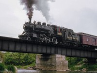 After dropping photographer's around the Credit River bridge, Ontario Rail Association's Credit Valley Railway 1057 pauses for photos before <a href=https://www.railpictures.ca/?attachment_id=59439>making a runpast</a> over the bridge in Mississauga's west end.  This trip ran from Toronto to Orangeville and return as part of the City of Brampton's centennial celebrations.

<br><br><i>Scan and editing by Jacob Patterson.</i>