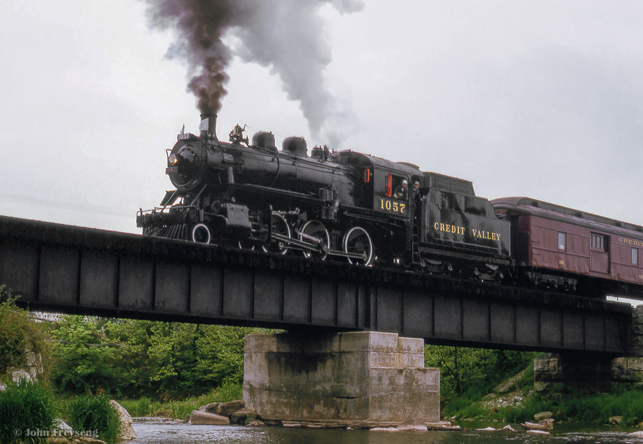 After dropping photographer's around the Credit River bridge, Ontario Rail Association's Credit Valley Railway 1057 pauses for photos before making a runpast over the bridge in Mississauga's west end.  This trip ran from Toronto to Orangeville and return as part of the City of Brampton's centennial celebrations.

Scan and editing by Jacob Patterson.