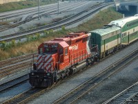 Shoving on the rear of a special shuttle train, CP SD40-2 5792 carries the markers on the west end of a set of GO bilevel coaches passing beneath Bathurst Street on approach to Union Station.  GO GP40TC 726 leads on the east end.  In September 1984, Pope John Paul II celebrated an outdoor mass in Downsview Park before an estimated 400,000 people. No car parking was allowed for the general public on or near Downsview Park, everyone attending was encouraged to take the TTC subway to Downsview and use shuttle bus/walk to the site of the mass. In addition to the above, GO ran a large number of extra trains on the Lakeshore Corridor to bring the Downsview Mass attendees to the Union Station where they would transfer to the University Line subway to Downsview, TTC running a rush hour schedule.  The pictured equipment would run up the Newmarket Sub to Rutherford Rd GO Station before proceeding to the makeshift platform built at the De Havilland air craft plant near Downsview to shuttle people who parked their cars at Rutherford GO to the mass.

<br><br><a href=https://www.railpictures.ca/?attachment_id=53079>GO Transit also borrowed CN power on this day.</a>

<br><br><i>Scan and editing by Jacob Patterson.</a>