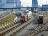 Shoving on the rear of a special shuttle train, CP SD40-2 5792 carries the markers on the west end of a set of GO bilevel coaches passing beneath Bathurst Street on approach to Union Station.  GO GP40TC 726 leads on the east end.  In September 1984, Pope John Paul II celebrated an outdoor mass in Downsview Park before an estimated 400,000 people. No car parking was allowed for the general public on or near Downsview Park, everyone attending was encouraged to take the TTC subway to Downsview and use shuttle bus/walk to the site of the mass. In addition to the above, GO ran a large number of extra trains on the Lakeshore Corridor to bring the Downsview Mass attendees to the Union Station where they would transfer to the University Line subway to Downsview, TTC running a rush hour schedule.  The pictured equipment would run up the Newmarket Sub to Rutherford Rd GO Station before proceeding to the makeshift platform built at the De Havilland air craft plant near Downsview to shuttle people who parked their cars at Rutherford GO to the mass.

<br><br>Looking closer at the Spadina facilities at right, CN 8516 is handling the usual coach yard chores, while an interesting piece of equipment from Speno lingers in the background.  Images of Speno rail grinding trains have appeared here before with converted GP38s and F40s, but this unit, appearing to be double ended, may be one of Speno's <a href=https://www.flickr.com/photos/chuckzeiler/27790786999>Rail Surface Analyzer</a> cars.  These did operate in Canada, one run being mentioned in the comments by Ron B, who piloted it Toronto - Guelph Junction - Hamilton.

<br><br><a href=https://www.railpictures.ca/?attachment_id=53079>GO Transit also borrowed CN power on this day.</a>
<br><a href=https://www.railpictures.ca/?attachment_id=25466>Speno in Jasper</a>
<br><a href=https://www.railpictures.ca/?attachment_id=40809>Speno in Capreol</a>
<br><a href=https://www.railpictures.ca/?attachment_id=35883>Speno at Bayview</a>

<br><br><i>Scan and editing by Jacob Patterson.</a>