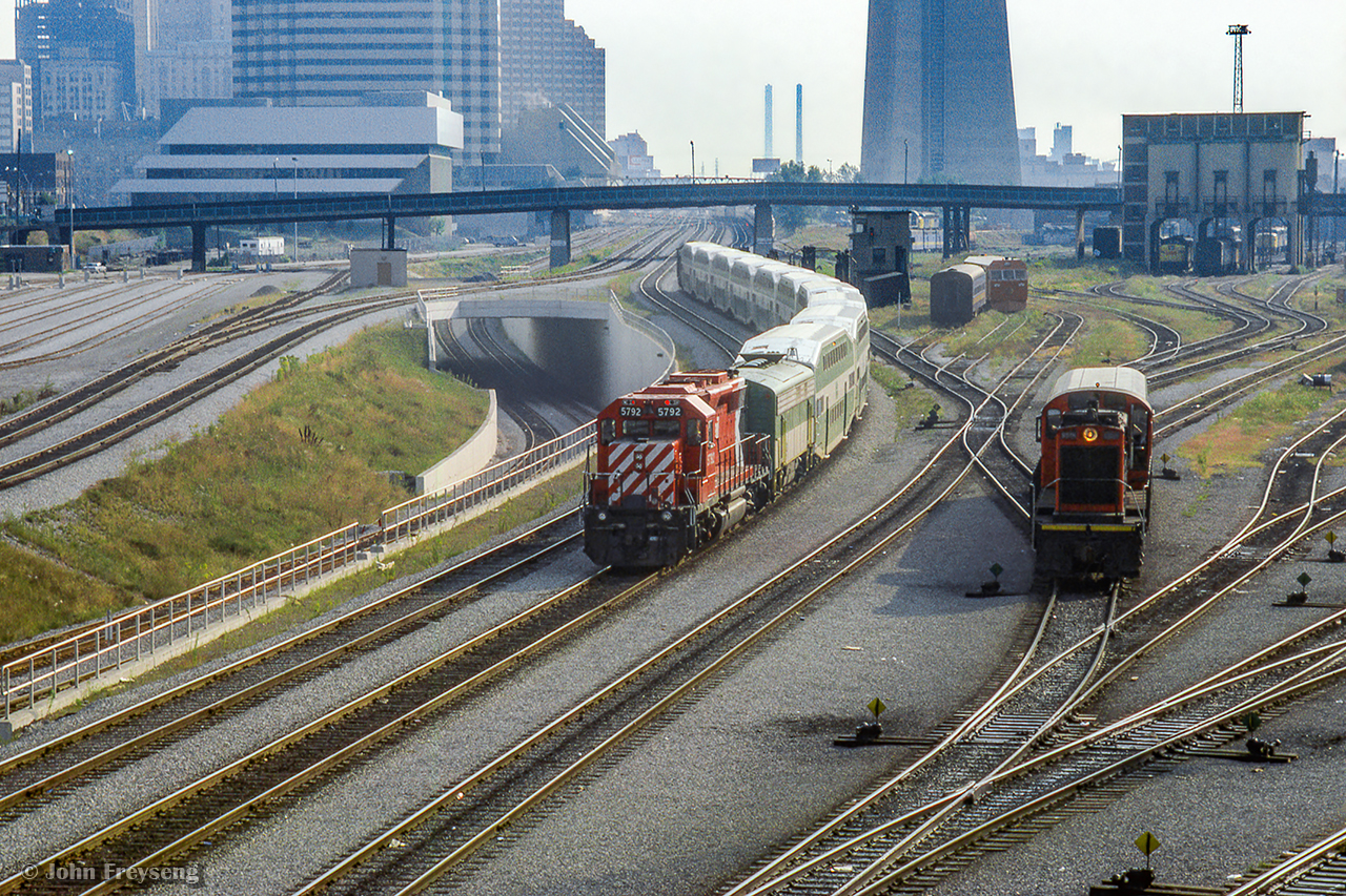 Shoving on the rear of a special shuttle train, CP SD40-2 5792 carries the markers on the west end of a set of GO bilevel coaches passing beneath Bathurst Street on approach to Union Station.  GO GP40TC 726 leads on the east end.  In September 1984, Pope John Paul II celebrated an outdoor mass in Downsview Park before an estimated 400,000 people. No car parking was allowed for the general public on or near Downsview Park, everyone attending was encouraged to take the TTC subway to Downsview and use shuttle bus/walk to the site of the mass. In addition to the above, GO ran a large number of extra trains on the Lakeshore Corridor to bring the Downsview Mass attendees to the Union Station where they would transfer to the University Line subway to Downsview, TTC running a rush hour schedule.  The pictured equipment would run up the Newmarket Sub to Rutherford Rd GO Station before proceeding to the makeshift platform built at the De Havilland air craft plant near Downsview to shuttle people who parked their cars at Rutherford GO to the mass.

Looking closer at the Spadina facilities at right, CN 8516 is handling the usual coach yard chores, while an interesting piece of equipment from Speno lingers in the background.  Images of Speno rail grinding trains have appeared here before with converted GP38s and F40s, but this unit, appearing to be double ended, may be one of Speno's Rail Surface Analyzer cars.  These did operate in Canada, one run being mentioned in the comments by Ron B, who piloted it Toronto - Guelph Junction - Hamilton.

GO Transit also borrowed CN power on this day.
Speno in Jasper
Speno in Capreol
Speno at Bayview

Scan and editing by Jacob Patterson.