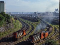 Looking east from the Young Avenue bridge, CN MLW RSC17 1776 works a cut of container flats in Halifax yard, while RS18 3660 sits off to the left.  Note the string of Bombardier locomotives, possibly in storage, at upper left.

<br><br><i>Scan and editing by Jacob Patterson.</i>