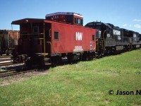 During a hot summer afternoon, Norfolk & Western caboose 555019 along with Norfolk Southern C39-8 8617 and C36-7 8531 await their next call to duty at the CN yard in St. Thomas, Ontario. Van 555019 was one of several NW cabooses assigned to Canada. 