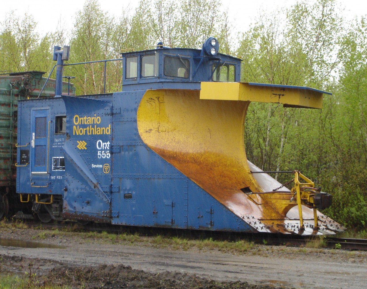 Rainy day plow  
Single track snowplow ONT 555 sits in the rain on a deadline at North Bay, ON May 19, 2009.