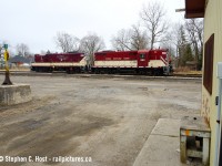 A pair of OSR GP7's are switching in St. Thomas yard and I framed them between the CN yard office and the interesting decorations found on the property. Since this photo was taken, the CN yard offices have all been razed and removed.  



