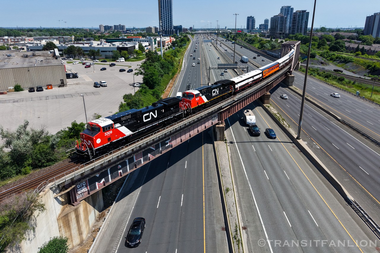 Diverging off the Kingston sub/GO sub corridor onto York sub at Liverpool, the Niagara wine tasting excursion CN P00731 20 with CN 3309/3412 slowed down to about half the track speed for passengers to have a good view over Hwy 401. (2026/07/20)