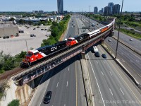 Diverging off the Kingston sub/GO sub corridor onto York sub at Liverpool, the Niagara wine tasting excursion CN P00731 20 with CN 3309/3412 slowed down to about half the track speed for passengers to have a good view over Hwy 401. (2026/07/20)