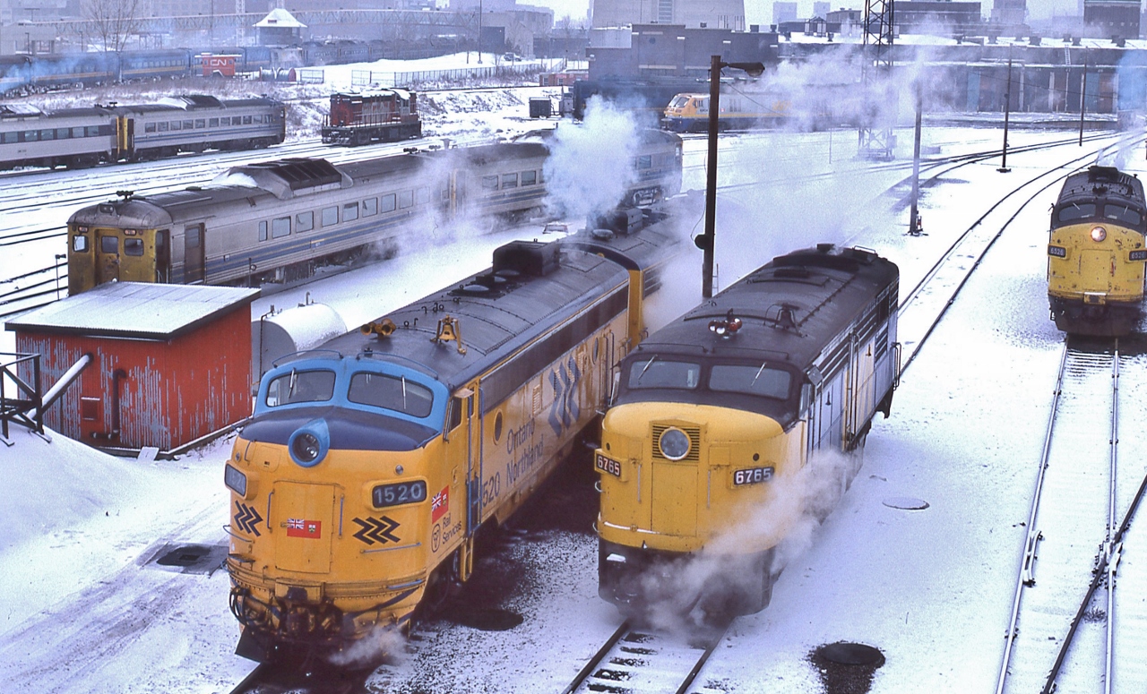 Something for every Fan...


Upper left, in front of the John Street TTR tower, a  string of VIA equipment including blue CC&F coaches, LRC loco and assorted Budd Cars


Upper centre: assorted Budd Cars, MLW 1960 built RS-18m CN 315x modified for Tempo service (and appears to be dead storage – by this time VIA had sold most Tempo equipment ( HEP equipment !) to the D&RGW for their Ski Train) and a  LRC loco, 


And front of  the above: for use at public events: the CN Safety Caboose (HEP equipped, ha ! )


The foreground:


GMD 1953 built FP7A: ONR 1520 and sister, one of 22 original deliveries, 1520 scrapped 2005/ 


MLW 1958 built FPA-4  ex CN VIA 6765, retired by 1989


GMD 1957 built FP9A ex CN  VIA 6526, the future 6313 then to Ohio Central April 2002


At CN Spadina, January 15, 1983 Kodachrome by S.Danko


also: just above the  RS-18m is the CN loop track, connecting at Spadina Ave. Mileage 0.69 Oakville Sub., that circled the roundhouse for turning consists.


sdfourty
