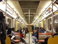 Here's some 1970's Retro Toronto goodness: the interior of TTC Hawker Siddeley Canada H4 5651, on a busy eastbound Bloor-Danforth train approaching Yonge Subway Station.<br><br>Standard fare on your average H4 always included the comfy orange and grey bench seats, yellow doorways with cream doors, and the ol' simulated wood grain paneling. Shot portrait-style to show off the large distinct rooftop ventilator fans, at the time the last subway cars in service in Toronto with them (also found in old department stores like K-Mart). All the <a href=http://www.railpictures.ca/?attachment_id=35183><b>H1-H4</b></a> cars came with those fans, as well as the <a href=http://www.railpictures.ca/?attachment_id=53526><b>M1's</b></a>, but their use was discontinued starting with the air-conditioned <a href=https://www.railpictures.ca/?attachment_id=59992><b>H5's</b></a>. The early H's were also "camshaft control", so no buzzing like the later "chopper control" cars, just a whir on starting and stopping, and no air conditioning either. The final H4 train would run a few months later in January 2012.<br><br>More H4 photos:<br>Davisville Subway Station: <a href=http://www.railpictures.ca/?attachment_id=34861><b>http://www.railpictures.ca/?attachment_id=34861</b></a><br>Christie Subway Station: <a href=http://www.railpictures.ca/?attachment_id=31197><b>http://www.railpictures.ca/?attachment_id=31197</b></a><br>Keele Subway Station: <a href=http://www.railpictures.ca/?attachment_id=34662><b>http://www.railpictures.ca/?attachment_id=34662</b></a><br>H4 ride (Youtube via another RP.ca contributor): <a href=https://www.youtube.com/watch?v=-rxna_nbkug><b>https://www.youtube.com/watch?v=-rxna_nbkug</b></a>