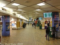 Another <a href=https://www.railpictures.ca/?attachment_id=59821><b>view</b></a> of the old retro 70's GO Transit concourse in the basement of Toronto Union Station (1979-2015) off Bay Street, looking east from the stairs leading down near the entrance from the VIA arrivals concourse (right by the McDonalds). It's just after 10pm and patronage is a bit lighter, with only a small handful of GO buses and trains shown on the screens waiting departure (evenings were the best for these kinds of photos, that both avoided the crowds and security). Most retail stores and restaurants here were winding down operations for the night, with a few convenient staples like the Gateway Newstands still open. Some of the GO ticket booths are visible in the distance, near the Bell payphones(!). Since this was the early days of PRESTO, there were still lots of POP ticket stamping machines in abundance to punch your 10-ride or your 2-ride.