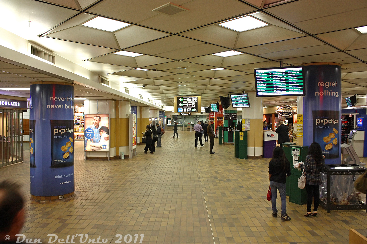 Another view of the old retro 70's GO Transit concourse in the basement of Toronto Union Station (1979-2015) off Bay Street, looking east from the stairs leading down near the entrance from the VIA arrivals concourse (right by the McDonalds). It's just after 10pm and patronage is a bit lighter, with only a small handful of GO buses and trains shown on the screens waiting departure (evenings were the best for these kinds of photos, that both avoided the crowds and security). Most retail stores and restaurants here were winding down operations for the night, with a few convenient staples like the Gateway Newstands still open. Some of the GO ticket booths are visible in the distance, near the Bell payphones(!). Since this was the early days of PRESTO, there were still lots of POP ticket stamping machines in abundance.