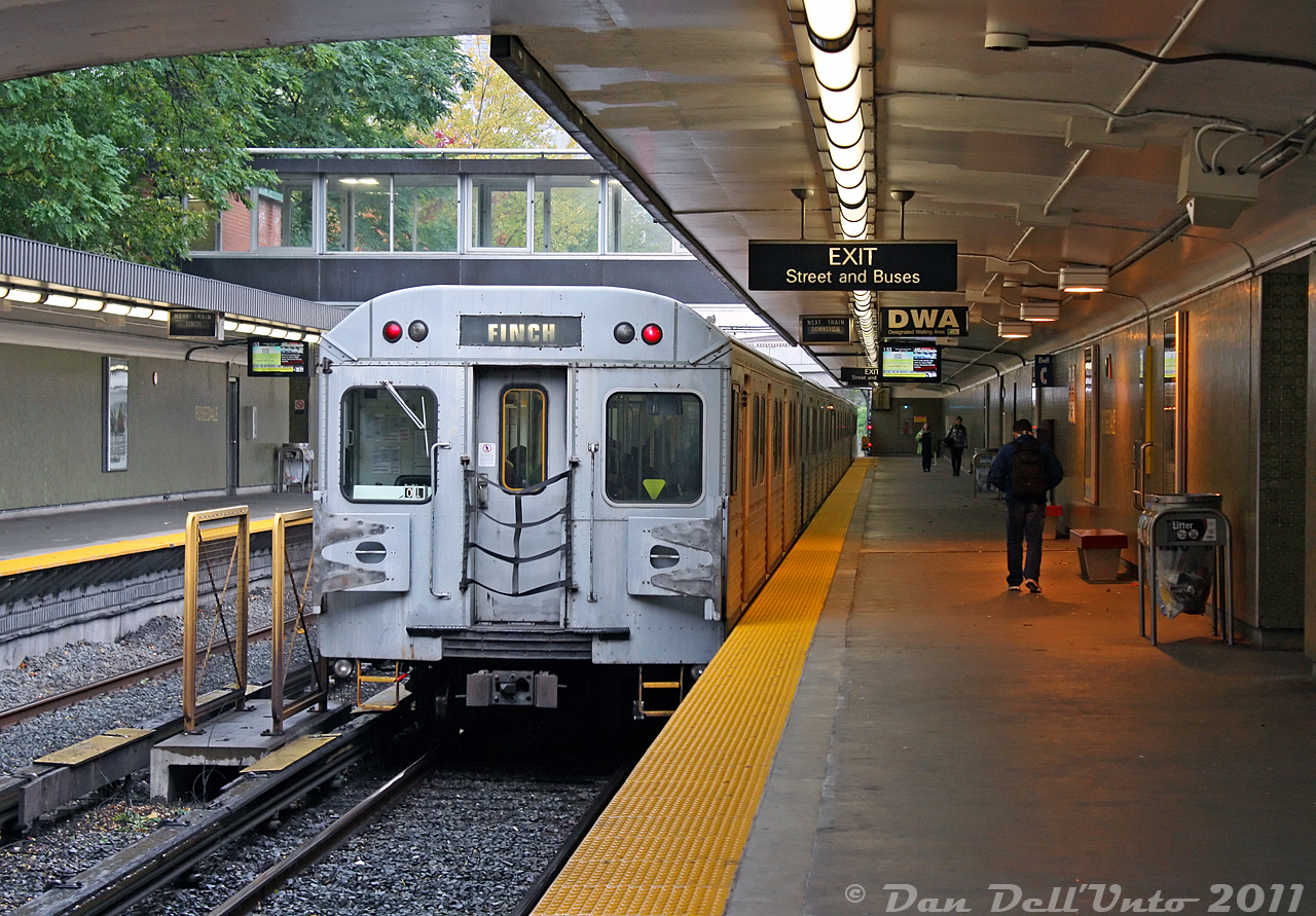 A bit of a rainy day outside along the open-cut section of the Yonge subway line finds TTC 5772 trailing a set of Hawker Siddeley H5's southbound, departing Rosedale Subway Station. Ridership is a bit sparse during afternoons at Rosedale, as evident here. The platform displays playing City Pulse (or City Panic, to some) 24 show showers, showers and more showers for the day, and they weren't wrong.