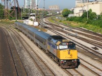 After completing its inbound run off the Weston Sub on VIA Rail train #86 (London-Toronto, big yawn for its early 5:20am departure to 8:13am arrival), F40PH-2D 6428 backs its consist of five Budd HEP2 coaches through Bathurst Street on a sunny morning back to the Toronto Maintenance Centre in Mimico. Typical of the era was the yellow add-on rooftop air conditioner (a few units were still running around without one). "Flap open" was normal for about half the VIA F40's you'd see on any given day until the rebuild program did away with that pesky flap by relocating the front MU plug to the pilot. Note the replacement numberboard on the engineer's side, the original possibly a victim of an errant bird while at speed.