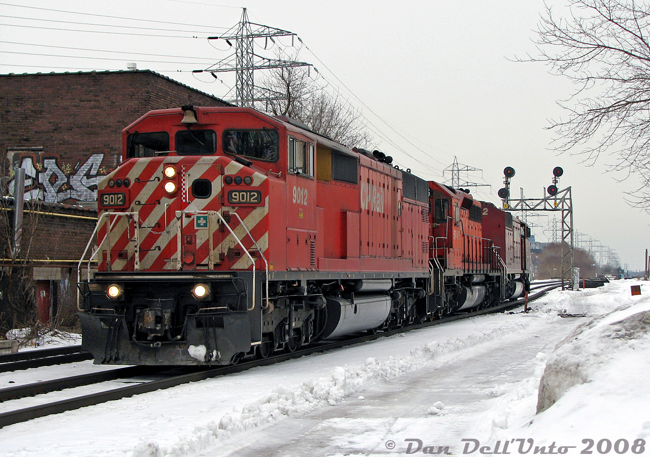 One CP Red Barn is nice, two is a treat, and an SD40-2 between is the cherry on top! CP SD40-2F units 9012 and 9022 bracket SD40-2 5746 on a very short train #223, running as light power from Toronto Yard to the Vaughan Intermodal Terminal to lift their train. The units are seen here about to cross Bartlett Avenue, heading westbound along CP's North Toronto Sub after CP #137 with a pair of SD40-2 units passed by. And earlier, CP transfer #T56 showed up with the ratty ex-Guilford 4652 leading.When the great Red Barn fleet fell, CP 9012 was sold to J&L Consulting for scrap in late 2016, but 9022 (one of only two repainted in the dual flags "System" livery) found its way back to CP after a stint operating on the Central Maine & Quebec Ry with a few other lucky SD40-2F survivors. 5746 was sold to K&K Recycling to become soup cans and new Hondas in 2017.