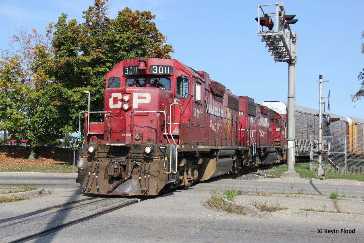 CP 3011 and 3099 work the Toyota plant in Cambridge with a pair of venerable GP38-2s in original CP paint. Now that several of CP's fleet of geeps are getting repainted into the corporate CPKC scheme, it is always refreshing to catch one in the original CP beaver scheme. They are pictured crossing Fountain St. in an area known as Hagey.