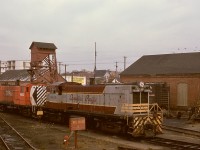 On the E&N shoptrack and sandhouse at Victoria on Thursday 1974-10-24, Baldwins CP 8000 and 8002 are ready to couple to northward freight train No. 51 to Stockett and down to Wellcox yard in Nanaimo.  CP 8000 survives and is being restored by the Railway Museum of British Columbia at Squamish, and the two brick buildings in this photo, stores on left and carshop on right, remain as part of a developing museum project in Victoria.  The sandhouse and CP 8002 are history.