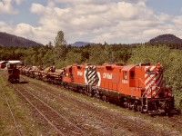 Clean GP9s CP 8664 and 8502 are shown on Friday 1979-05-18 at Lake Cowichan, assembling a train of log loads from Crown Zellerbach’s Nitinat Logging Division, hence the nickname Nitinat for such moves to Crown Zellerbach’s log dump into the saltchuck at Ladysmith.  The E&N depot at Lake Cowichan is to the right and behind my photo perch, and it survives to this day as the Kaatza Museum, slightly relocated from its original spot.