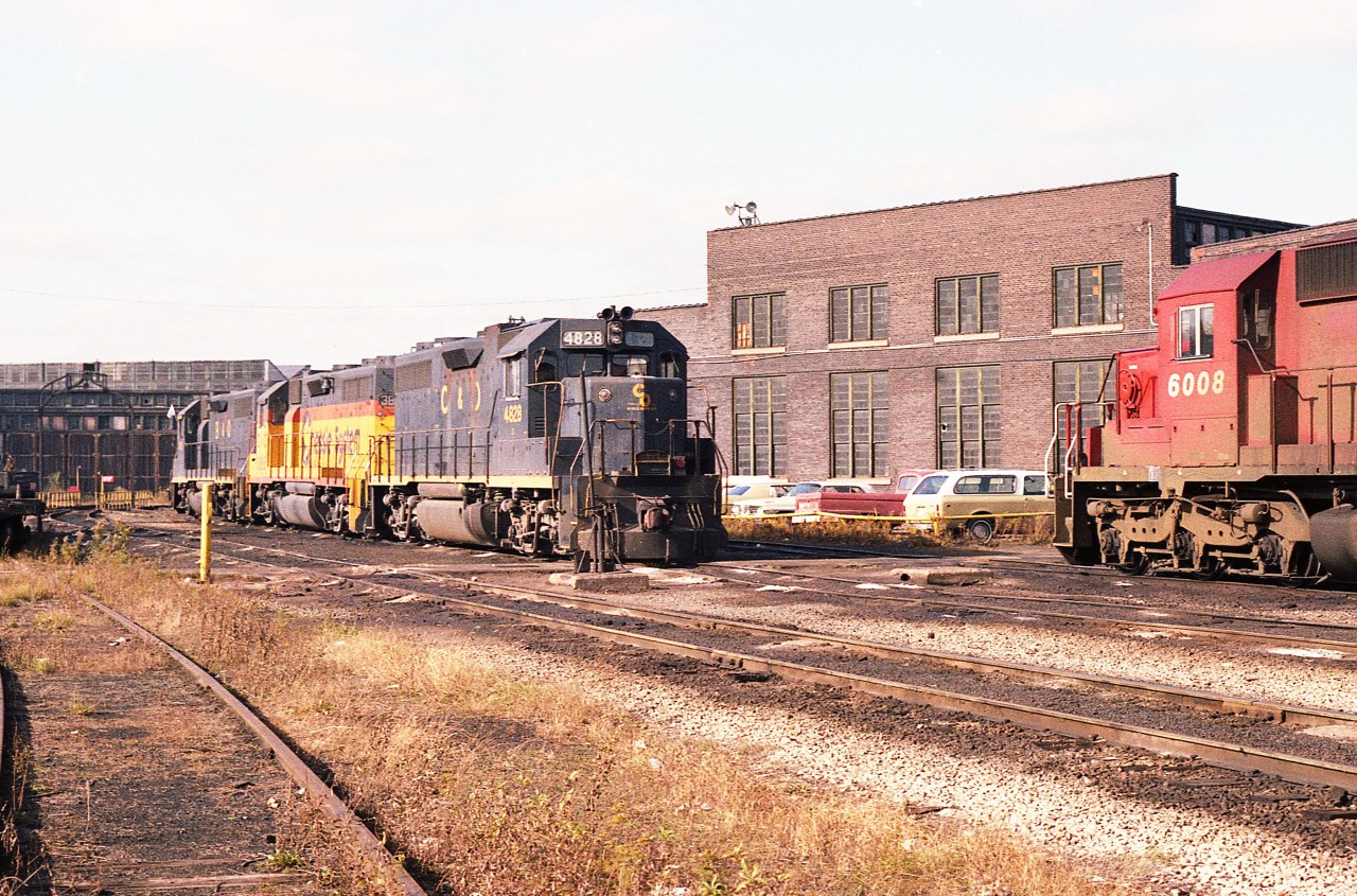 A fond look back on a beautiful November morning at TH&B Chatham St in West Hamilton. This was a place the Golden Horseshoe rail buffs made one of their focal points for photography.
Shown is the power for the Nanticoke train, C&O 4828, 3885 and B&O 4801.  The CP 6008 was one of several units parked off to the side. The old roundhouse can be seen in far left.
I loved the fact I was allowed to roam at will and the employees were very accommodating.
Unfortunately, when CP took complete control of the TH&B in 1987, it was only a matter of time before this facility would become but a memory.  Demolition in early 1992 spelled the end.