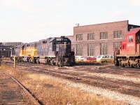  A fond look back on a beautiful November morning at TH&B Chatham St in West Hamilton. This was a place the Golden Horseshoe rail buffs made one of their focal points for photography.
Shown is the power for the Nanticoke train, C&O 4828, 3885 and B&O 4801.  The CP 6008 was one of several units parked off to the side. The old roundhouse can be seen in far left.
I loved the fact I was allowed to roam at will and the employees were very accommodating.
Unfortunately, when CP took complete control of the TH&B in 1987, it was only a matter of time before this facility would become but a memory.  Demolition in early 1992 spelled the end.