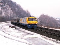 The head of a rather unforgettable class is seen rounding the bend by Dundas Peak heading westbound. The Bombardier LRC-2 (and -3) series were a period probably many VIA brass would rather forget. They were failure prone in so many ways, being overly high tech for their time. Engine leaks & failures, vibrations at speed; long runs at high speeds and harsh winters really did a number on them. The LRC-2 and -3 series did not last long on VIA, most of them not more than a dozen years.
When I first saw them; I thought "ugh", but now that their day is long gone, the old photos create historical interest.  Production run was from 6900 to 6930.