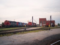 I submitted this just as a "refresh the memory" image. The CN Fort Erie diesel shop used to be such the interesting place to visit. Almost anything CN could be found from one day to the next, including locomotives such as the two GT noted here. From the left; CN 5099, GT 6424, 6423, CN 7306. Centre is CN 5175, unknown behind it, and what appears to be 4018 on the right.
Of interest too is the 8 man gang motor car CN 187-78 on the extreme right, Fairmont Railway Motors Model A4, built 1975. (This information, of course, from Paul O'Shell)
Heavy work wound down in 1987 and the shop facility closed for good in 1989.
Niagara Railway Museum opened utilizing this building in 2010 and now has an interesting collection of rolling stock and artifacts. Check on-line for information.