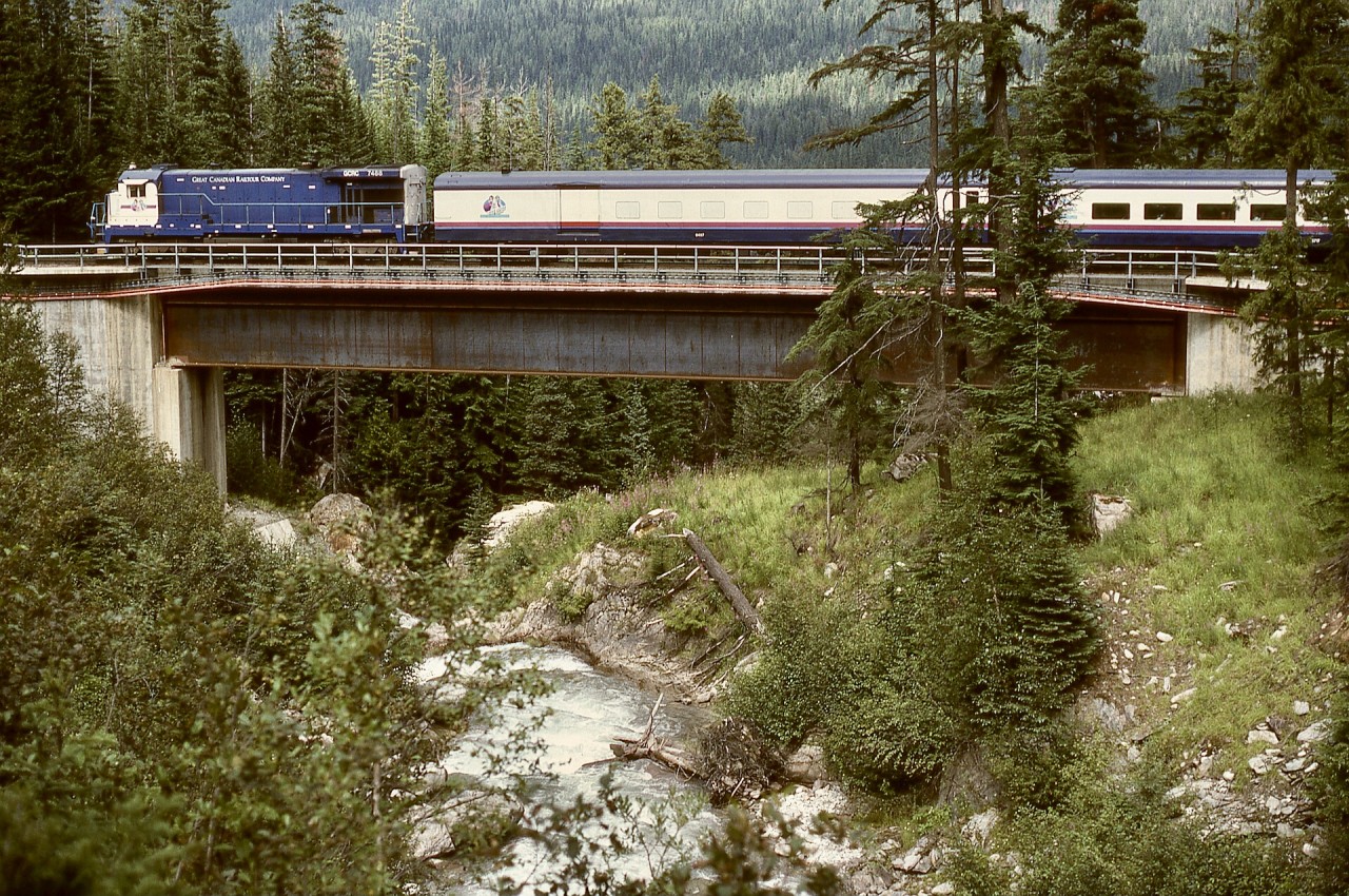 In 1995, Canadian Pacific closed the Connaught Tunnel route to allow deepening the tunnel to accommodate double-stacked container trains, requiring the Macdonald Track to carry both eastward and westward traffic, including Rocky Mountaineer passenger trains.  On Wednesday 1995-08-09, eastward GCRC 7488 crossed the Bear Creek bridge at Macdonald Track mileage 78.7M at 1433 PDT, just before entering the Shaughnessy Tunnel.