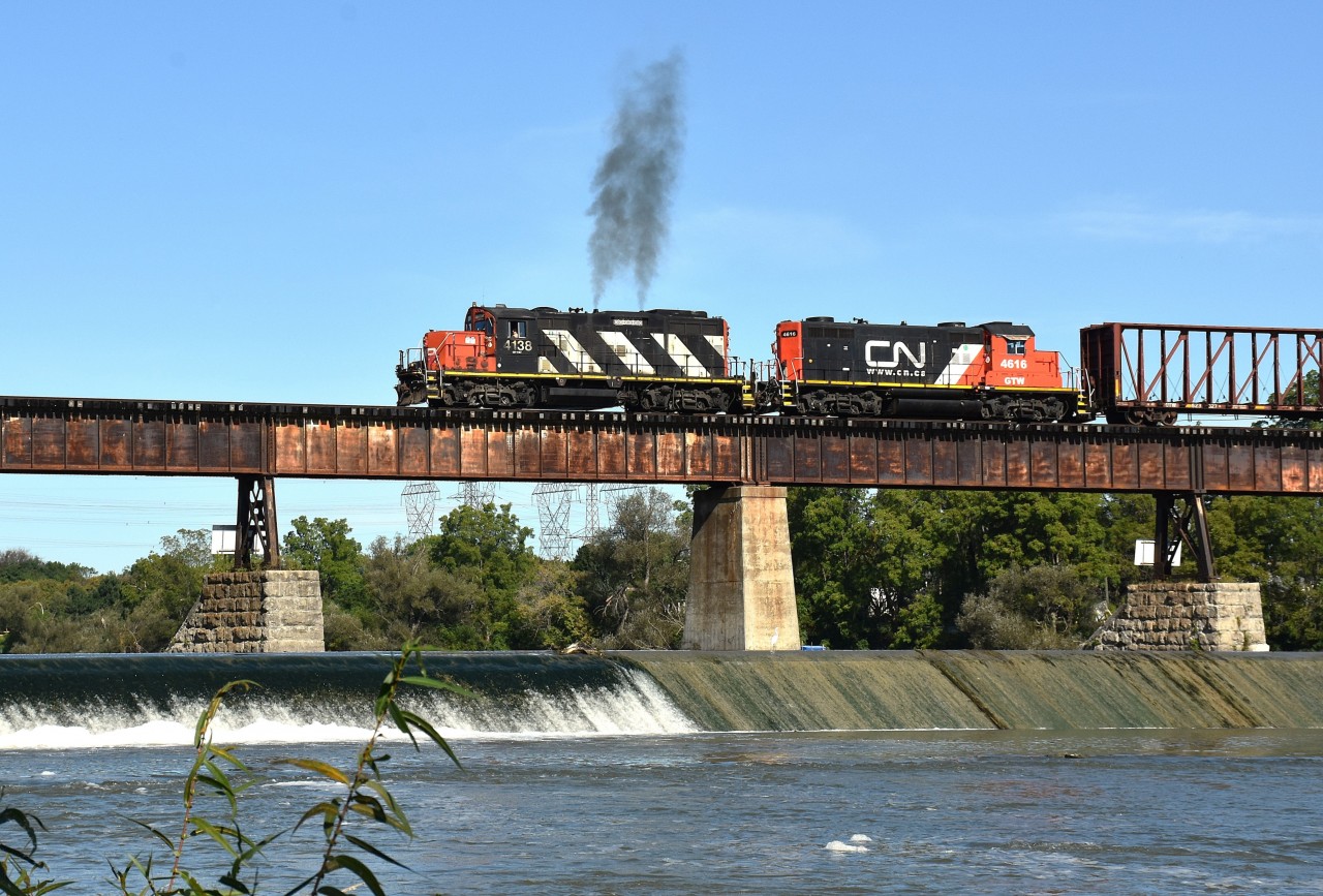 Today, the 18th of September, was an especially nice day to be out. Perfect temperature, clear skies and the bugs were out partying somewhere, I guess.
CN's 580 followed 502 over the bridge at Caledonia and 3/4 the way across gave us a little 'whoop' of the throttle.  Made for an okay shot worth sharing.  CN 4138 and GTW 4616.