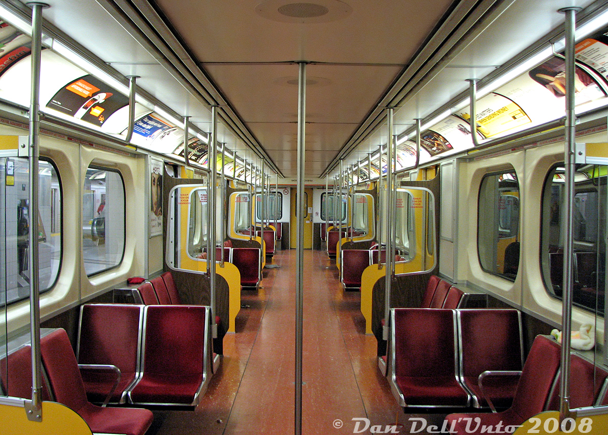 The interior of TTC H5 subway car 5791 is shown empty, at the end of the line at Finch Subway Station one evening. Empty interior shots could be tricky to get, but end terminus stations late at night (10pm) made it a bit easier, except for the errant hats and mitts and newspaper bits scattered about from a day of riding around Toronto in service.The distinct yellow doors and doorways were original to the H5-class of subway cars (5670-5807) when built new by Hawker Siddeley Canada the mid-1970's, but they originally featured orange velour seat inserts (eventually changed to red fabric, as seen here). TTC 5791 was one of the last cars to operate in service, on the final H5 train run on June 14th 2013.More H5's:Platform view at Finch: http://www.railpictures.ca/?attachment_id=10050Operator's cab interior: http://www.railpictures.ca/?attachment_id=59834New on delivery: http://www.railpictures.ca/?attachment_id=53581Meeting a CP freight: http://www.railpictures.ca/?attachment_id=54660At Dundas Subway Station: http://www.railpictures.ca/?attachment_id=34900At the scrapyard: http://www.railpictures.ca/?attachment_id=7336