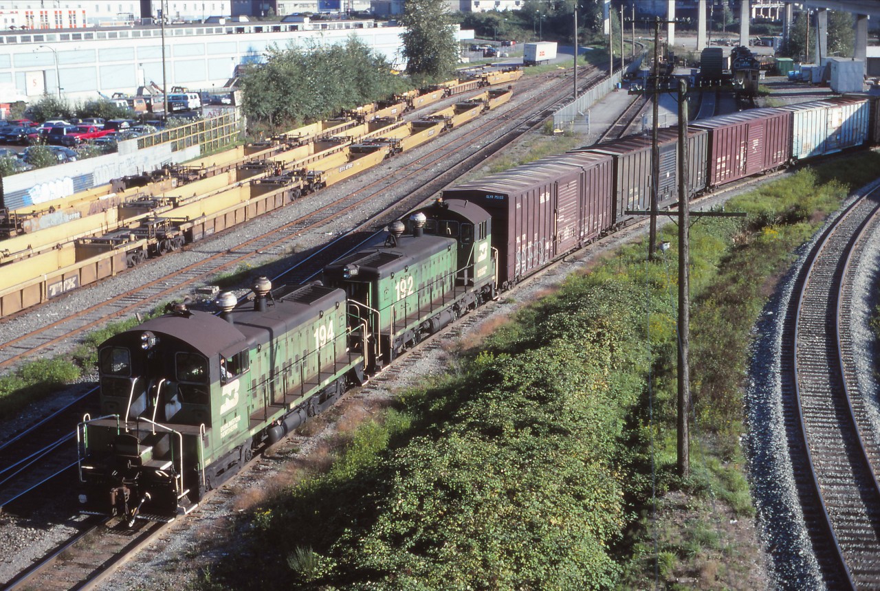 A business trip to Vancouver in 1995 gave me the opportunity to spend a Sunday shooting in the Vancouver area. While scouting locations to photograph the afternoon Amtrak departure from the Pacific Central station, I came across BN 194 and 192 (both former Northern Pacific SW1200s) which I believe were bringing cars from the nearby interchange yard (with CN and Southern Railway of British Columbia/former BC Hydro). This is still a BN train...the BNSF merger will take place 12 days from now (22 September 1995).