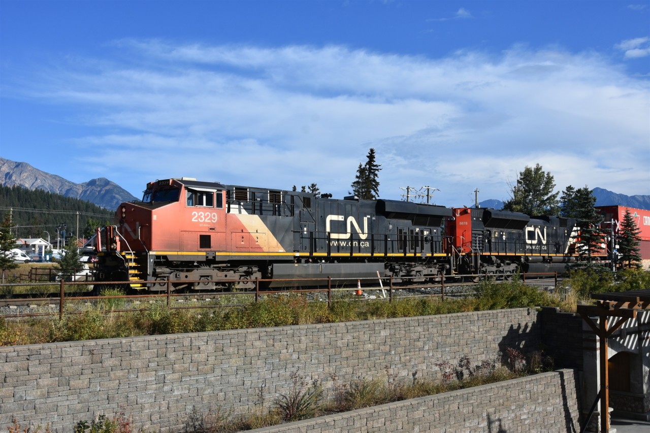 Cans west  
CN 2329 with CN 8878 in tow and a lengthy train of double stacks has just cleared the Hazel Ave. crossing at the west end of Japer Yard to continue the westbound journey with a fresh crew on board.