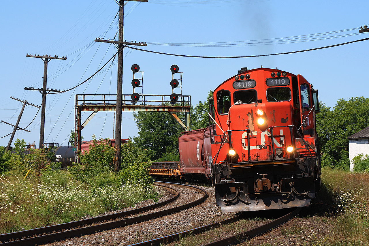 Hot summer's day, end of July, and I was shooting everything this day. Being out for nearly 8 hours, this was near the start. After some training of office personnel at Nith Rd (Paris West), and clearance of other trains in the area...the conductor hopped back into the cab of 4119. With a puff of exhaust, they're back on their way to the yard in Brantford.
