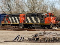 Nothing like a cool, sunny Spring morning. Although I was on my way to Napanee, I made a day out of stopping at certain locations that never usually disappoint in terms of 'action'. 
<br>
<br>
Here, CN veterans 4125 and 4121 are bringing back a cut of cars. The trackage they're on I believe connected at one point to the old Canadian Northern main. This would've been back before the creation of CN. When the CNoR and GTR became CN, I believe that CN reconfigured some of their industrial tracks using the former CNoR main line. After all, it was just a few hundred meters away. 
<br>
<br>
Also, note the stacks of rails, ties and other 'junk' that these engines are passing. This is the former 'yard' at the station. All removed, when VIA built a behemoth pedestrian bridge with new platforms. 