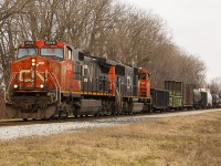 Not sure why I was down in this area, however, went out looking and saw a set of headlights in the distance. 
<br>
<br>
Here, CN 2548 as well as another unidentified unit, lead train 439 <a href="https://railwaypages.com/i-j-k"> past the site of the old station. </a> 
<br>
<br>
It was also in this area, that back in 1854 near where the line carried over Baptiste Creek at the edge of town, that one of Canada's most deadliest train accidents occurred (in this photo, about where the train fades off into the horizon). For more information, you can <a href="https://www.chatham-kent.ca/visitck/doandsee/outdooractivities/Pages/Baptiste-Creek-Train-Disaster.aspx"> read about it here. </a>