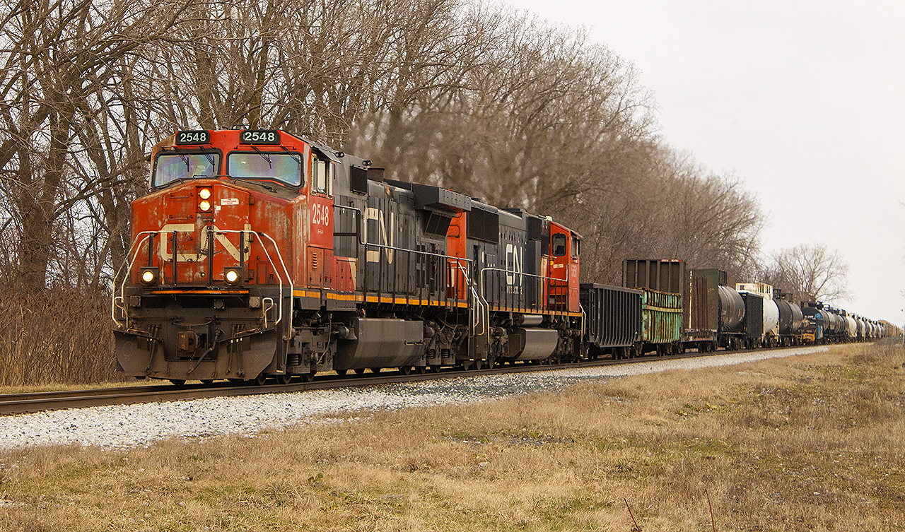 Not sure why I was down in this area, however, went out looking and saw a set of headlights in the distance. 


Here, CN 2548 as well as another unidentified unit, lead train 439  past the site of the old station.  


It was also in this area, that back in 1854 near where the line carried over Baptiste Creek at the edge of town, that one of Canada's most deadliest train accidents occurred (in this photo, about where the train fades off into the horizon). For more information, you can  read about it here.