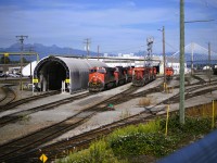 <b> Power to spare </b> <br>Heading east out of Vancouver's Pacific Central station on VIA 002 'The Canadian' mid-afternoon provides for a well-lit scene at CN's Thornton Yard in Surrey, BC. <br>The 11 units visible in this shot are just a small sample of the power that was on display at the shop and yard on this sunny August 31st afternoon. <br>Thornton Yard stretches for miles beyond this point passing the diesel shop, car repair, Engineering facilities, Fleet Services (automotive) and a huge intermodal complex.