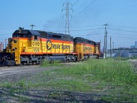 C&O 7526/7553, with the daily transfer "The Puller", are seen departing the CP's Windsor Yard. They are briefly on the Essex Terminal before getting on the loop track over to CN and CP's CASO Sub for a trip through the Detroit River Tunnel as they make their way back to Rougemere Yard in Dearborn Michigan. This is a scan of a Bernie Drouillard Kodachrome original and posted with permission.