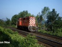 Trundling east from Guelph Jct, the CP “Stone Train” with solo 8205 negotiates the many curves east of the Kelso ski hill as it descends the Niagara Escapement heading to Streetsville, Ontario on the Galt Subdivision. The GP9u, minus a caboose today, was able to get out of the junction amongst the weekday morning eastbound parade of five empty GO Transit sets that would also head eastbound to Milton to load daily commuters for trips into Toronto. 