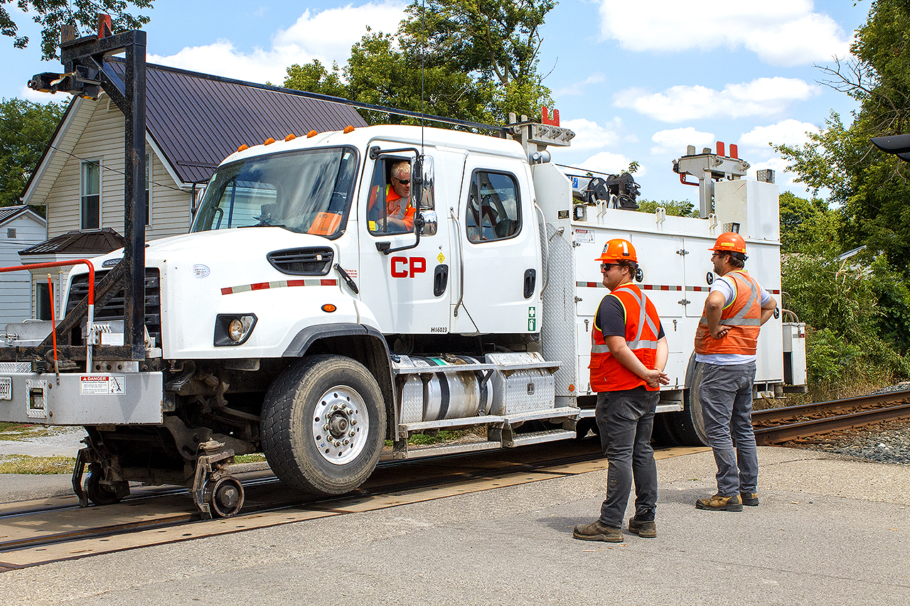 You never know what you'll see when you come out of work, on your lunch break. Here, CPKC crew talk things over, with their supervisor about the continued plan of attack. The brush had overgrown so badly along the Windsor Subdivision that many train crews were reporting of the branches hitting their train as they passed through. The railway took action, bringing in a crane and making quick 'carnage' out of the overhanging brush.

Photo was taken with permission from the crew, following their safety tips and instructions.