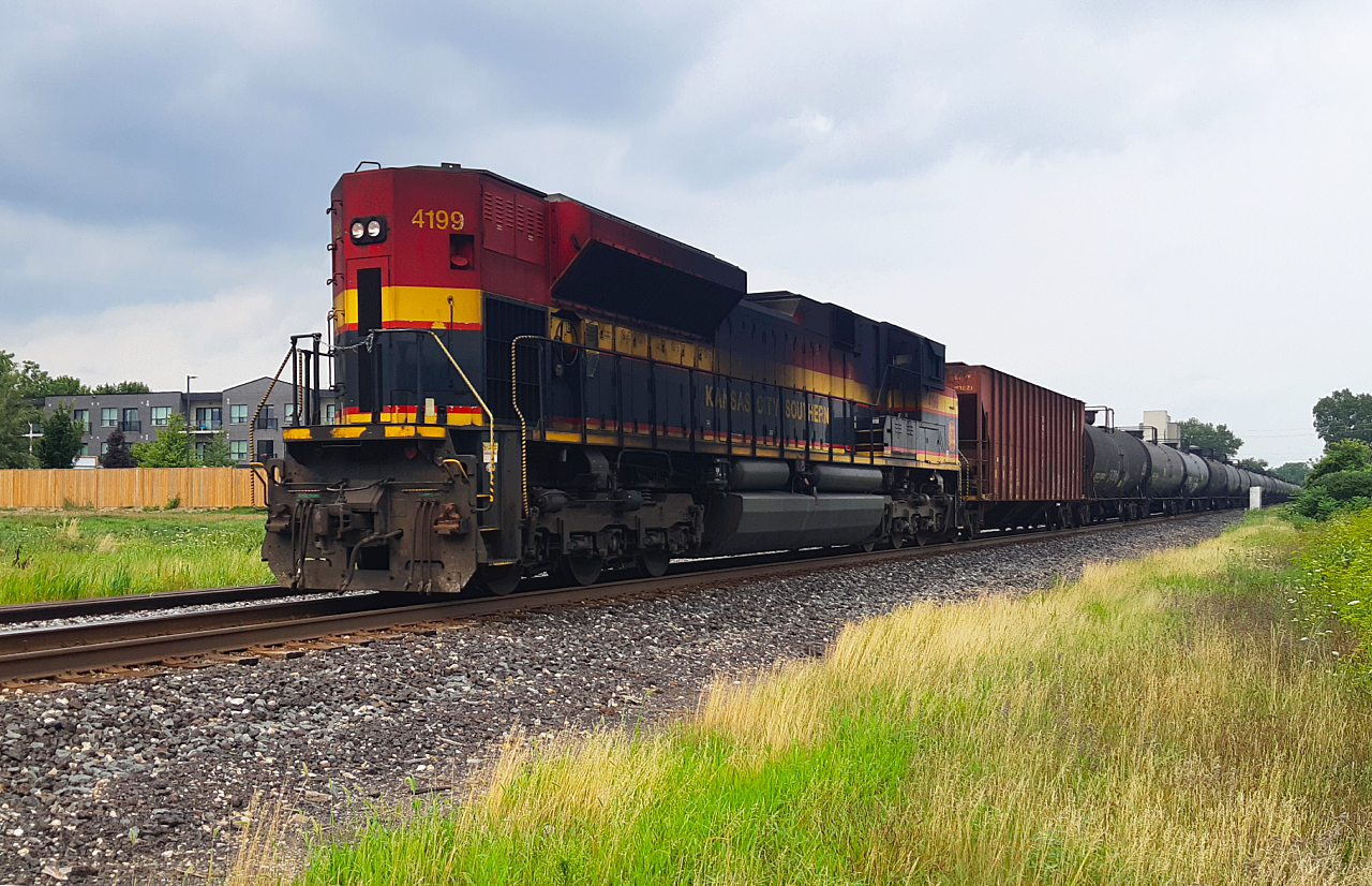 Once the pride of the south, this 'Belle' certainly became like other power. Roadworthy, yet grungy. Acting as DPU on eastbound 528, KCS (CPKC) 4199 pushes on.