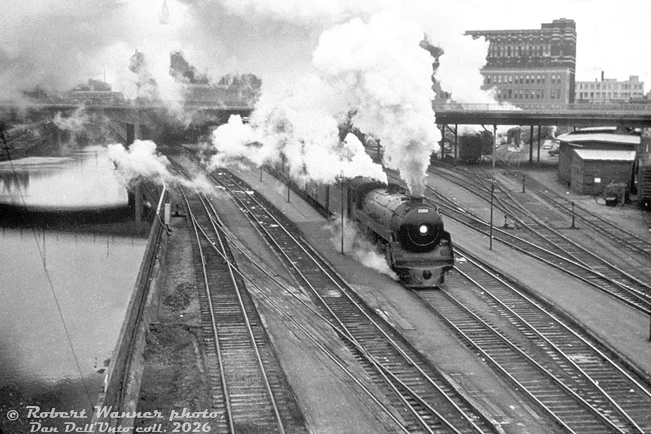 Canadian Pacific Railway "Royal Hudson" H1d 2858 (built by MLW in 1938) departs Ottawa's Union Station with train #504 to Montreal on a cold day in late 1955, seen alongside the Rideau Canal showing the Mackenzie King bridge and downtown Ottawa railway facilities that were once located here. The downtown Ottawa Union Station closed in 1966 when the station and railway facilities were relocated to a new station built outside of the downtown area, eliminating the trackage running along the Rideau Canal. The old station building later became the Government Conference Centre. After retirement, 2858 was one of a handful of Royal Hudsons preserved, going to the Canadian Museum of Science and Technology in Ottawa.

There's some dispute about the exact date of the photo. Photographer Robert Wanner notes it was taken in late October 1955 (also mentioning this is one of his favourite CPR steam photos), but the description on the mount of this duplicate slide shows November 4th 1955, and yet other photo sources show December 2nd 1955.

Airman Robert Wanner photo, Dan Dell'Unto collection slide (duplicate).