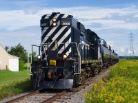 An MLW in your backyard? Chemin de fer Lanaudière with RS-18 3000 is heading south towards Joliette, Qc and interchange with the Quebec Gatineau Railway. 