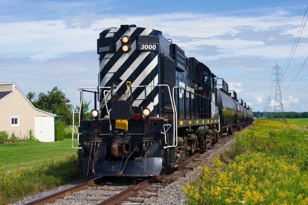 An MLW in your backyard? Chemin de fer Lanaudière with RS-18 3000 is heading south towards Joliette, Qc and interchange with the Quebec Gatineau Railway.