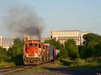 GTW 5820 is the leader on CN YRP003 as it heads towards Getpaq during some nice evening light as trailer CN 4134 smokes it up.