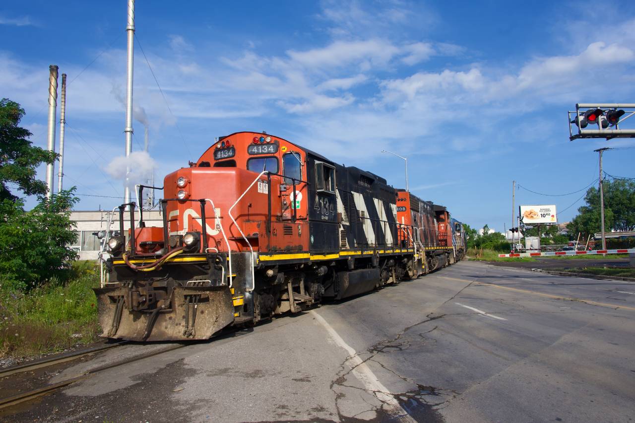 CN 4134 leads CN YRP002 over the Marien Avenue crossing.