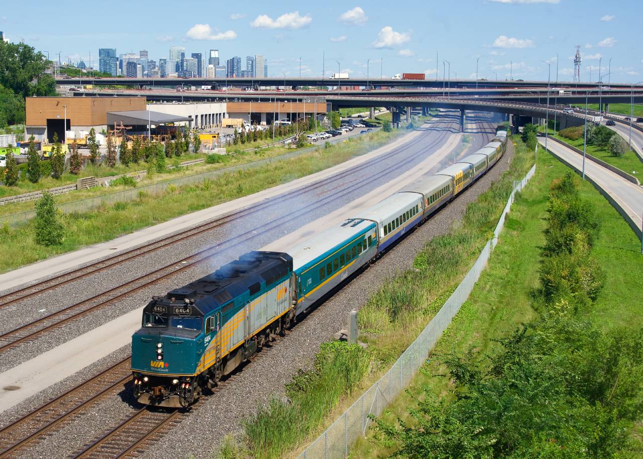 VIA 67 has ten cars as it heads west with VIA 6404 letting out some smoke.