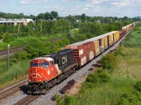 In a welcome break from gevos, CN 8303 leads CN 369 past MP 14 of the Kingston Sub.