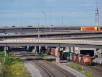 A high headlight SD70M-2 leads CN 401 from underneath the Turcot Interchange.
