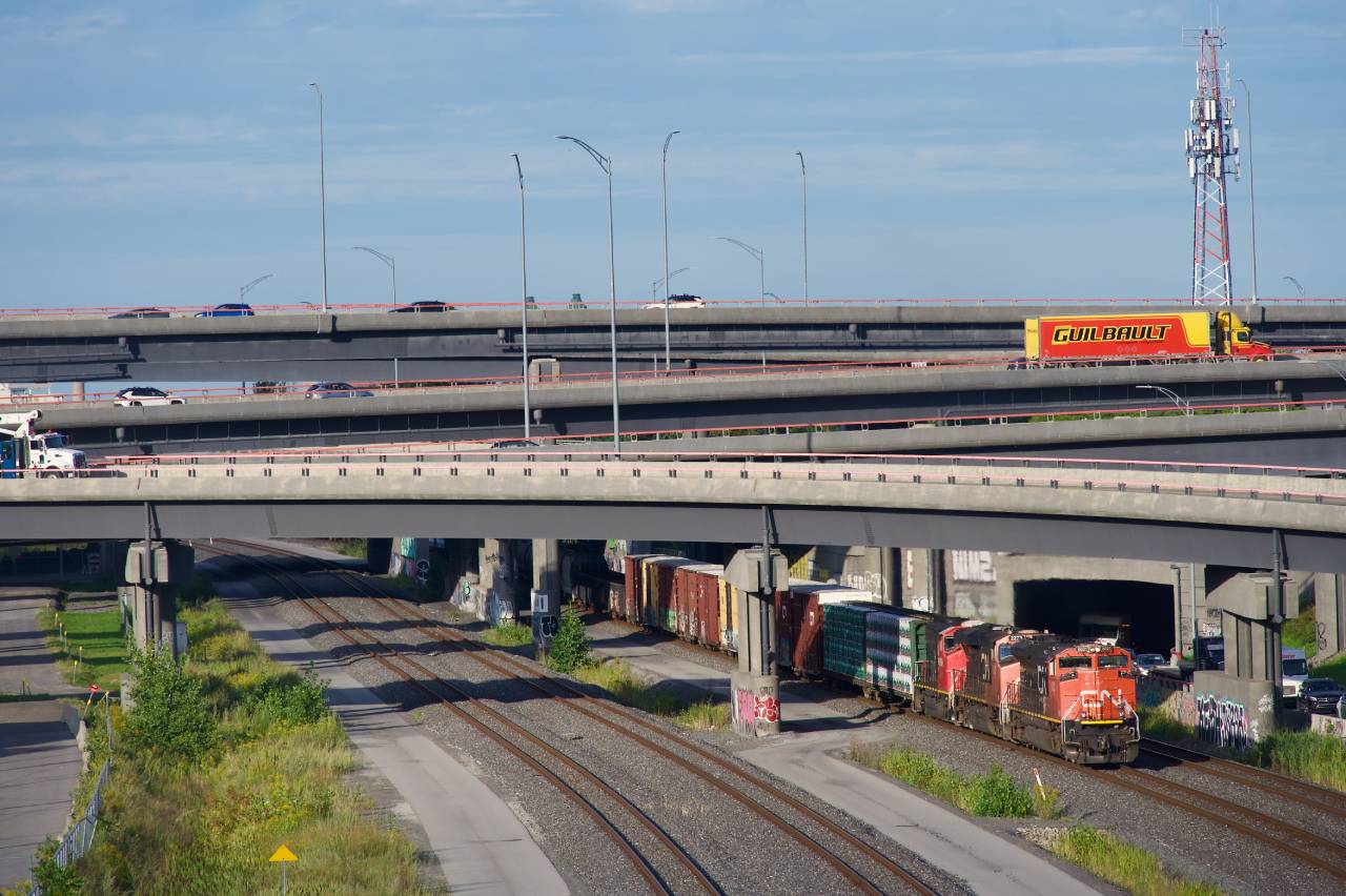 A high headlight SD70M-2 leads CN 401 from underneath the Turcot Interchange.